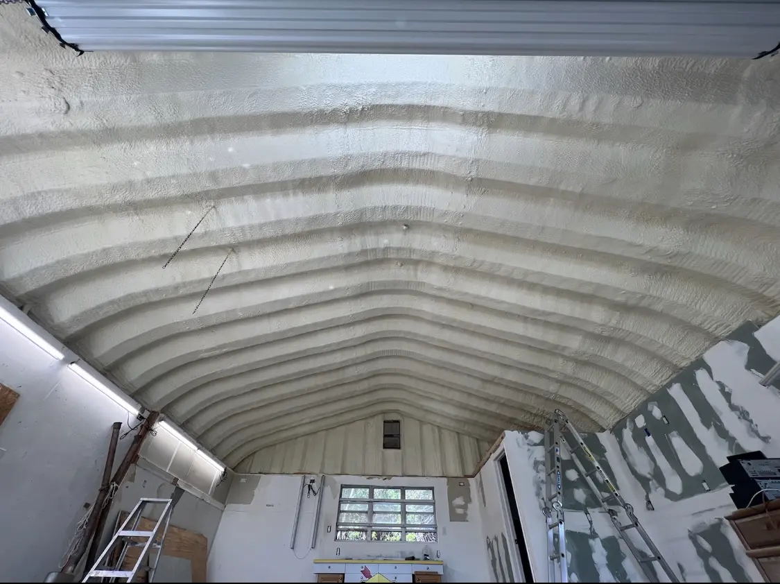 Spray polyurethane foam applied to the underside of a metal roof deck in Waukee